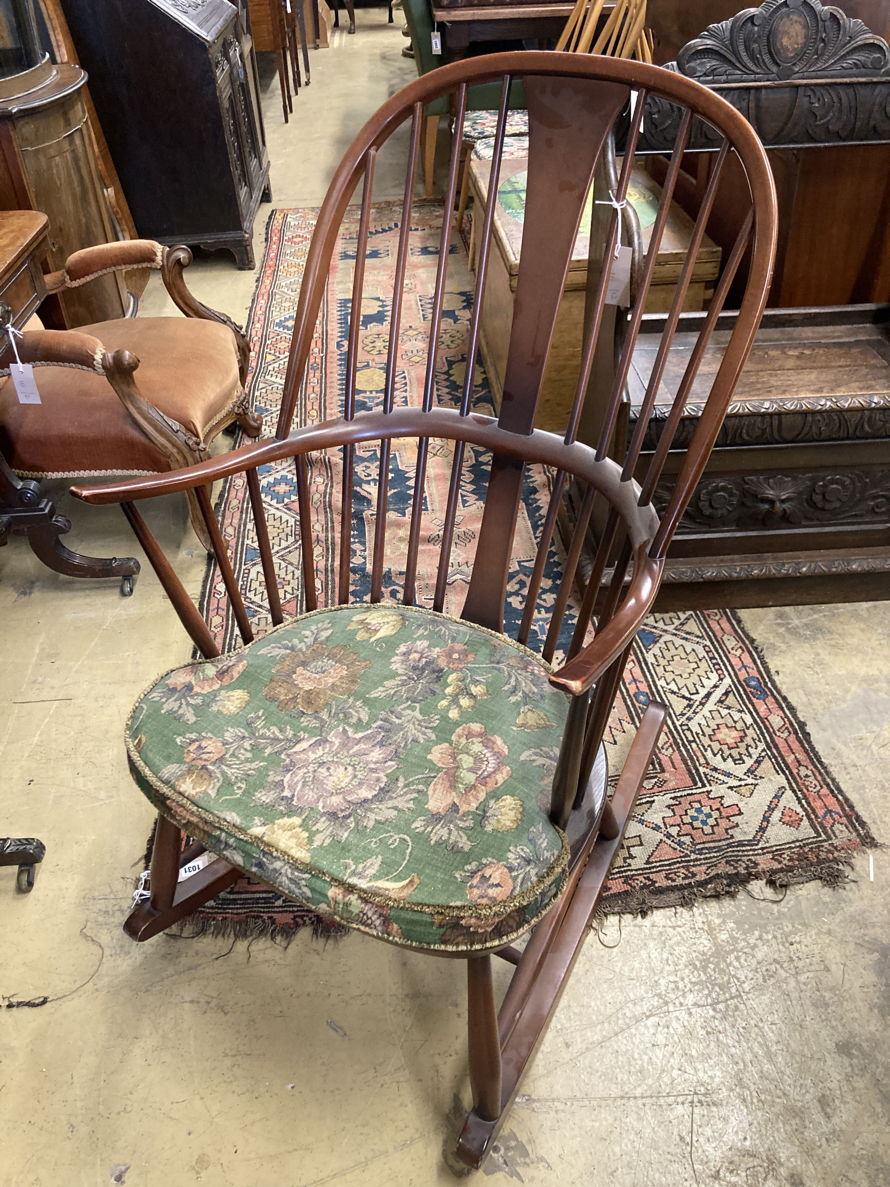 An Ercol comb back stained beech rocking chair, width 60cm, depth 50cm, height 106cm